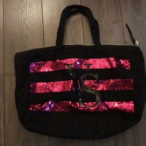A black Victoria secret bag with pink sequins